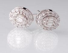 A pair of 18ct white gold and diamond cluster earrings. The earrings having three baguette cut