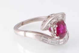 An Art Deco ruby and diamond crossover ring. The ring set with a certificated Thai Ruby with no