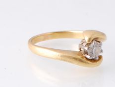 An 18ct Gold & Diamond Solitaire Crossover Ring