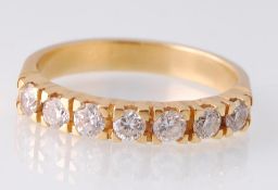 An 18ct gold 7 stone diamond ring. The ring set with 7 round brilliant cut diamonds on a plain