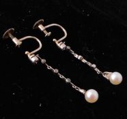 A pair of Belle Epoque diamond and pearl drop earrings. The earrings having a single pearl