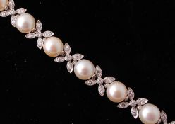 A French signed Sterle Paris cultured pearl and diamond bracelet. The bracelet strung with 11