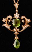 An Art Nouveau 15ct gold peridot and pearl pendant brooch necklace chain.
