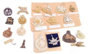 COLLECTION OF ORIGINAL WWII CAP BADGES AND BERET B