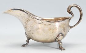 An early 20th Century silver hallmarked sauce / gr