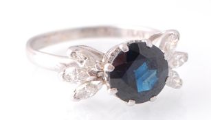 A PLATINUM SAPPHIRE AND DIAMOND FLOWER HEAD RING