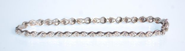 A 9ct white gold ladies bracelet with illusion set diamonds. The bracelet having a box clasp.
