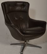 A retro mid century swivel egg chair  having a 4 point chrome swivel base with faux black leather