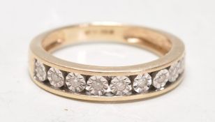 A 9ct gold hallmarked diamond channel set half eternity ring. The ring with 9 diamonds being