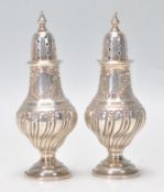 A good matching pair of late 19th Century Victorian silver hallmarked pepperette table condiments