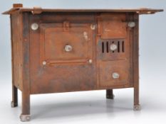 A 19th Century Victorian cast iron model of a stove / oven having a series of doors to the front