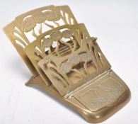 An early 20th Century Art Nouveau brass desktop letter rack having floral decoration to the