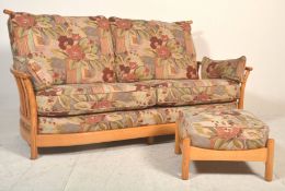 A good Ercol Saville light elm three seater sofa settee having raised spindle back with shaped