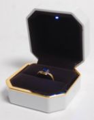 A restored medieval gold ring, circa 1200 - 1500 having a rectangular headset with a polished blue