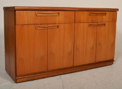 A retro mid 20th Century G Plan teak wood sideboard credenza raised on a plinth base having two