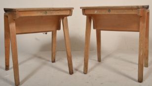 A pair of mid century beech wood school desks being raised on bentwood arched legs with hinged