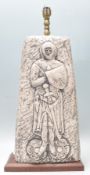 A vintage retro 1970's table lamp having a square faux stone body with carved knight decoration,