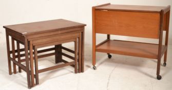 A good retro 20th Century teak wood tea trolley having two drop leafs with second tier below