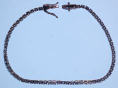 An 18ct white gold tennis bracelet set with round cut diamonds totalling approx 3.3cts. Measures