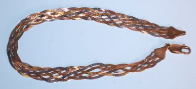 A ladies three tone 9ct gold bracelet constructed from four woven flat chains. Clasp marked 375.