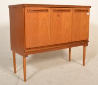 A retro mid 20th Century G Plan teak wood sideboard credenza having three cupboard doors below a