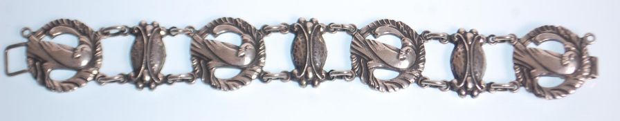 A vintage ladies silver bracelet having round panels with pierced decoration in the form of doves.