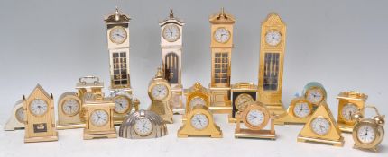 A collection of brass and yellow metal miniature novelty quartz clocks (mostly by Estyma) many in