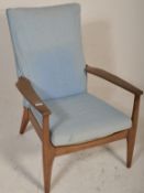A vintage mid century Parker Knoll  armchair. The chair with square tapering legs and shaped elbow