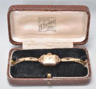 A vintage hallmarked 9ct gold cased ladies wrist watch having a mother of pearl face with Arabic