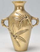 A believed 19th century Chinese brass / bronze twin handled vase having cast and embellished