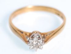 An 18k yellow gold ladies ring having a raised flower head mount set with a single white stone.