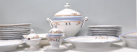 A late 19th / early 20th Century ceramic dinner service having bands of blue, orange and black