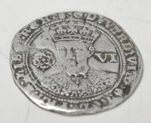 A silver hammered sixpence of Edward VI (1547-1553) dating to c. 1551-1553.  Obverse: EDWARD. [VI