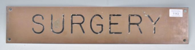 A vintage 20th Century enameled brass exterior medical surgery door / wall plate reading 'Surgery'.