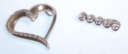 Two platinum and diamond pendants to include a heart shaped pendant set with round cut diamonds