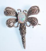 A stamped 925 silver brooch in the form of a dragon fly set with an opal and marcasites. Measures