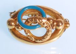 A 19th Century Victorian 18ct gold ladies brooch having a blue enamel decoration to rounded center
