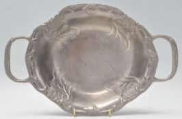 An early 20th Century Art Nouveau twin handled pewter tray having repousse floral decoration.
