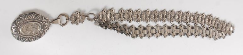 A vintage silver necklace having finley engraved panel links with a large locket pendant with