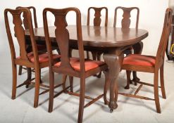 A 1920s mahogany extending dining table with cabriole legs along with 6 queen anne style dining