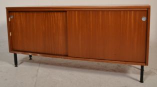 A retro mid 20th Century teak wood sideboard credenza raised on black metal supports having twin