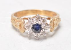 A hallmarked 9ct yellow ladies ring set with a central round facted cut blue stone with a white