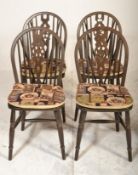 A set of four 20th Century wheelback dining chairs raised on turned legs united by H stretchers