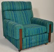 A retro mid century teak wood and upholstered easy chair / armchair. Upholstered in the original