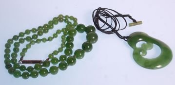 A vintage 20th Century Chinese green jade prayer bead necklace having a graduating set of round