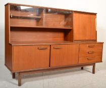 A retro 20th Century teak wood highboard sideboard credenza, being raised on square supports having