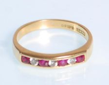 An English hallmarked 18ct yellow gold ladies ring set with alternating red and white round cut