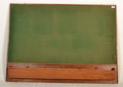 A mid century vintage village hall  notice board with baize lined centre in wooden surround having
