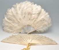 A lovely early 20th Century feather fan having mother of pearl sticks. Together with a 19th