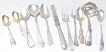 A collection of American silver flatware to include a Sterling stamped ladle, 1909 dated sterling